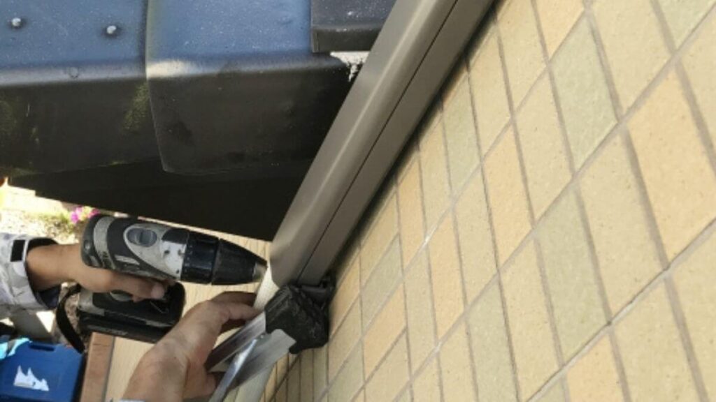 配管カバーを設置する業者の男性
